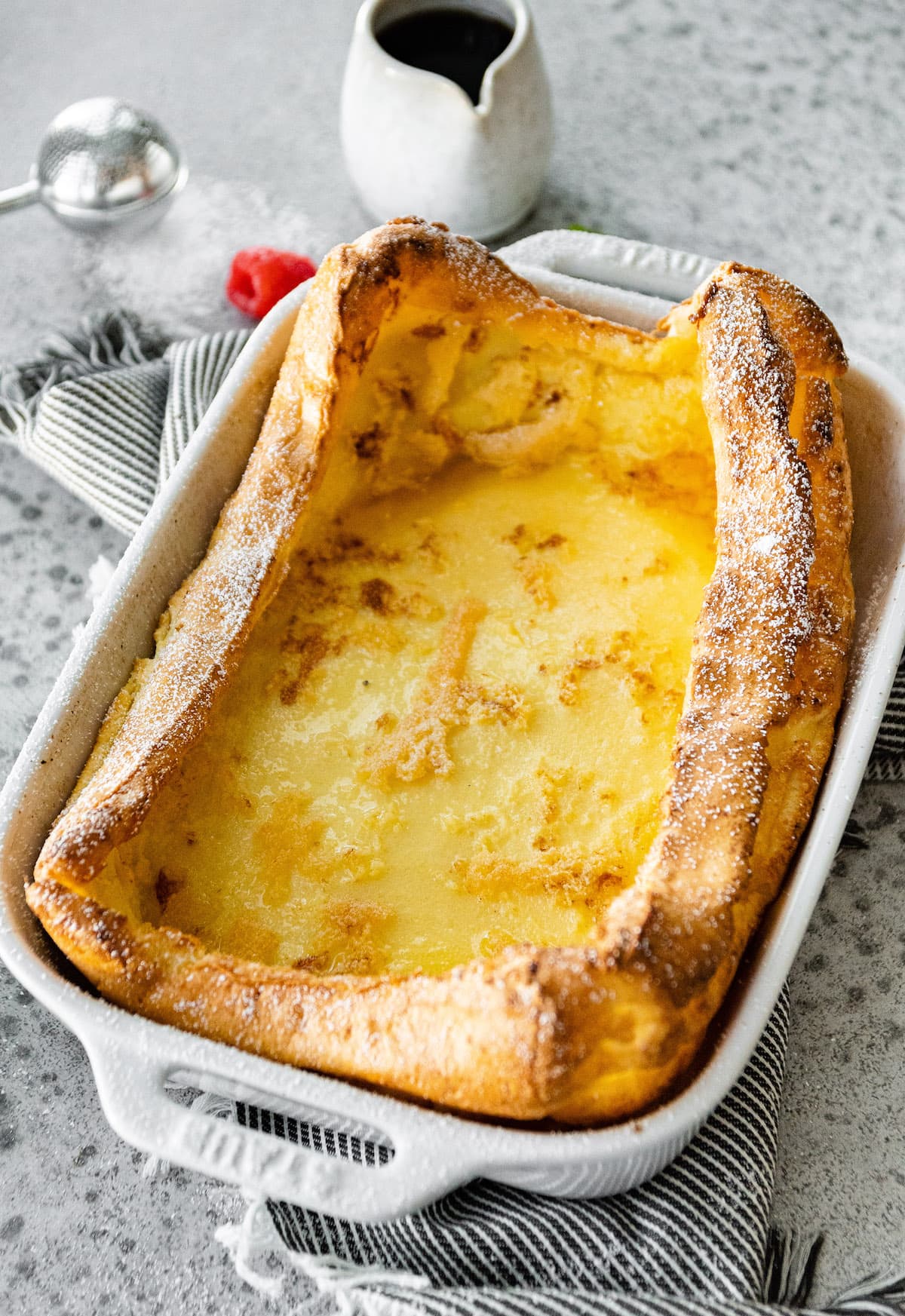 German Pancake in pan with powdered sugar. 