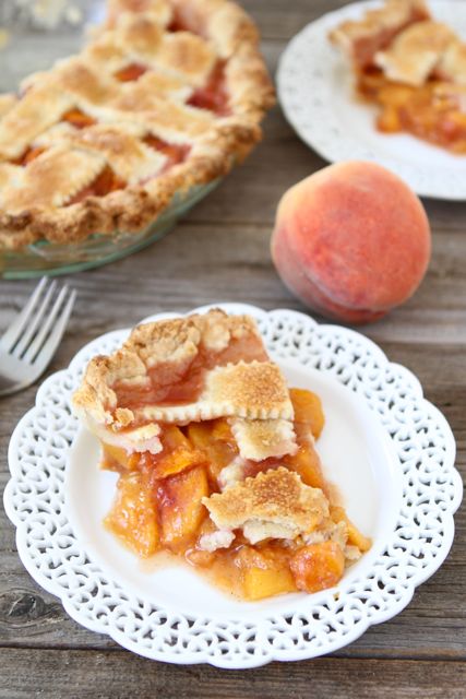 Peach pie slice with peach pie filling on plate