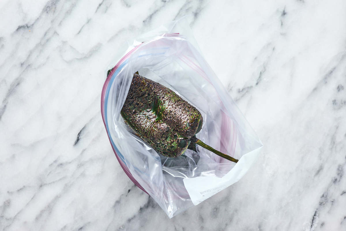 charred poblano pepper steaming in bag. 