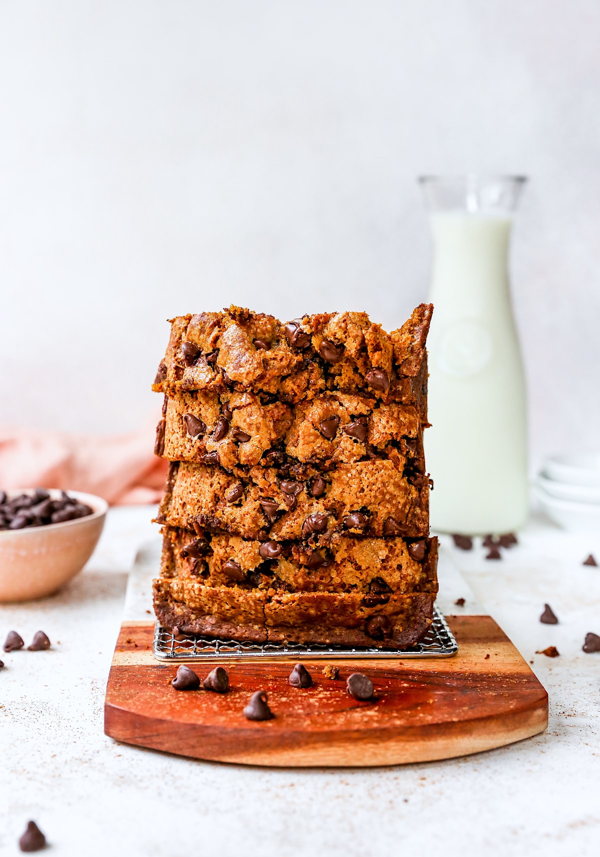 pumpkin chocolate chip bread slices stacked with bottle of milk. 