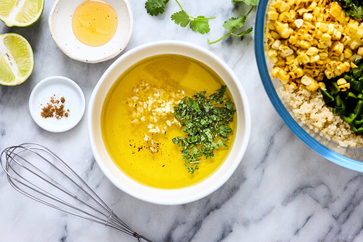 cilantro lime dressing in bowl with whisk. 