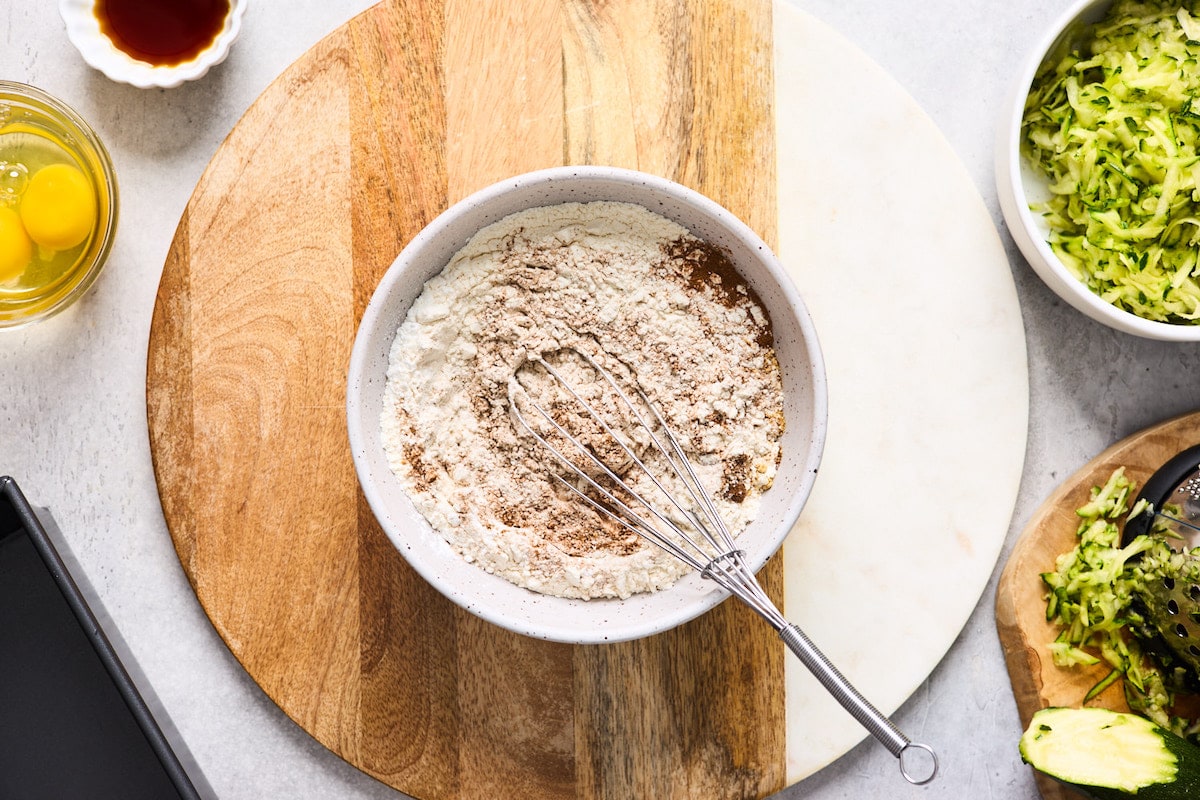 dry ingredients being whisked together in mixing bowl. 