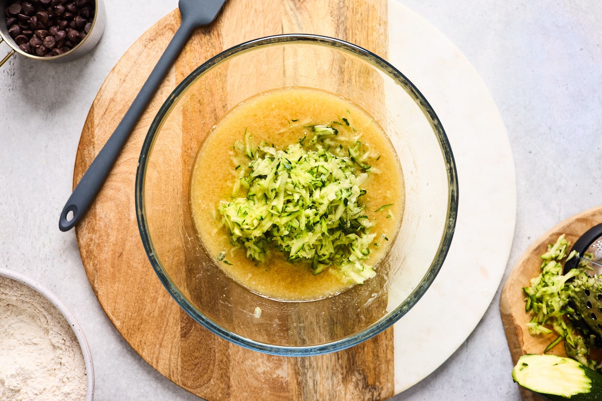 liquid ingredients and shredded zucchini in mixing bowl. 