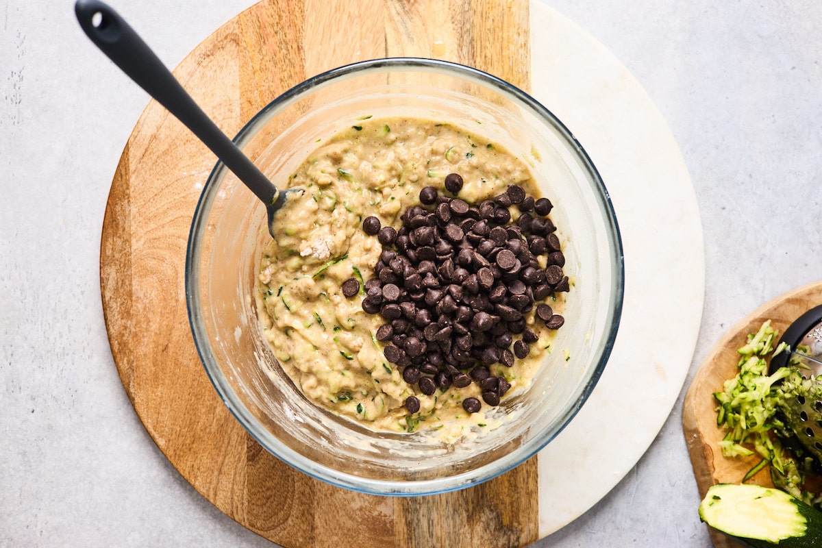 healthy zucchini bread batter in mixing bowl with chocolate chips. 