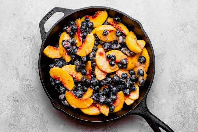 blueberry peach crumble ingredients in pan