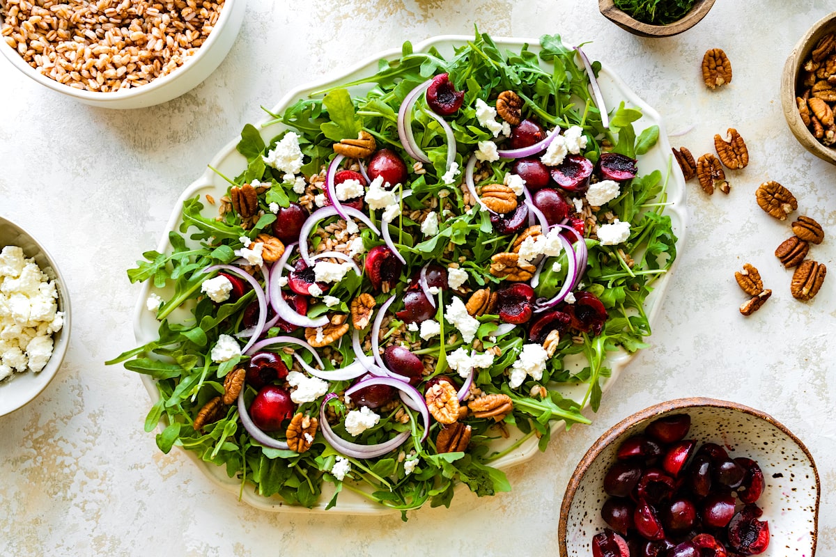 cherry arugula salad on platter. 