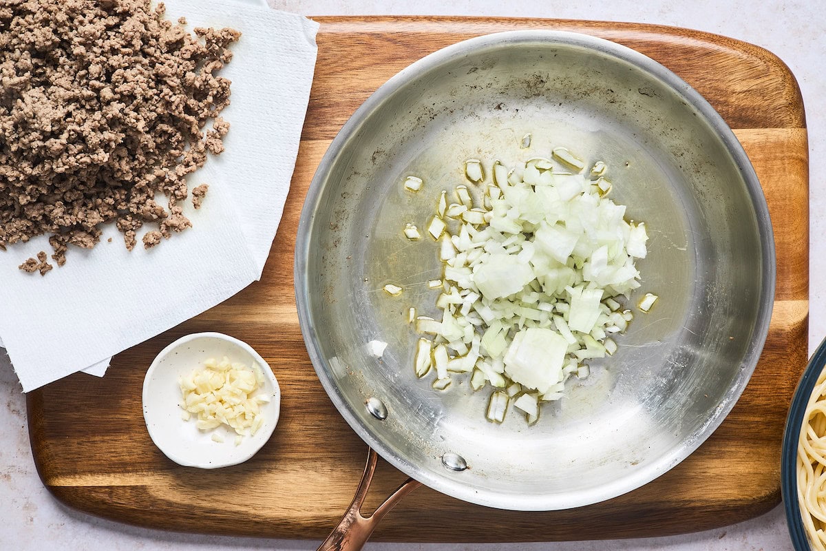 onion cooking in skillet to make baked spaghetti. 