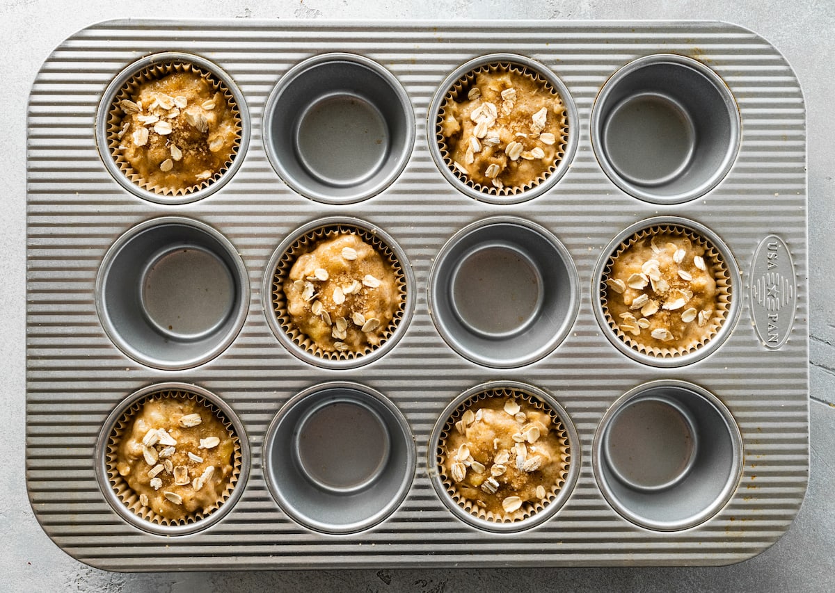 banana oatmeal muffin batter in muffin pan. 