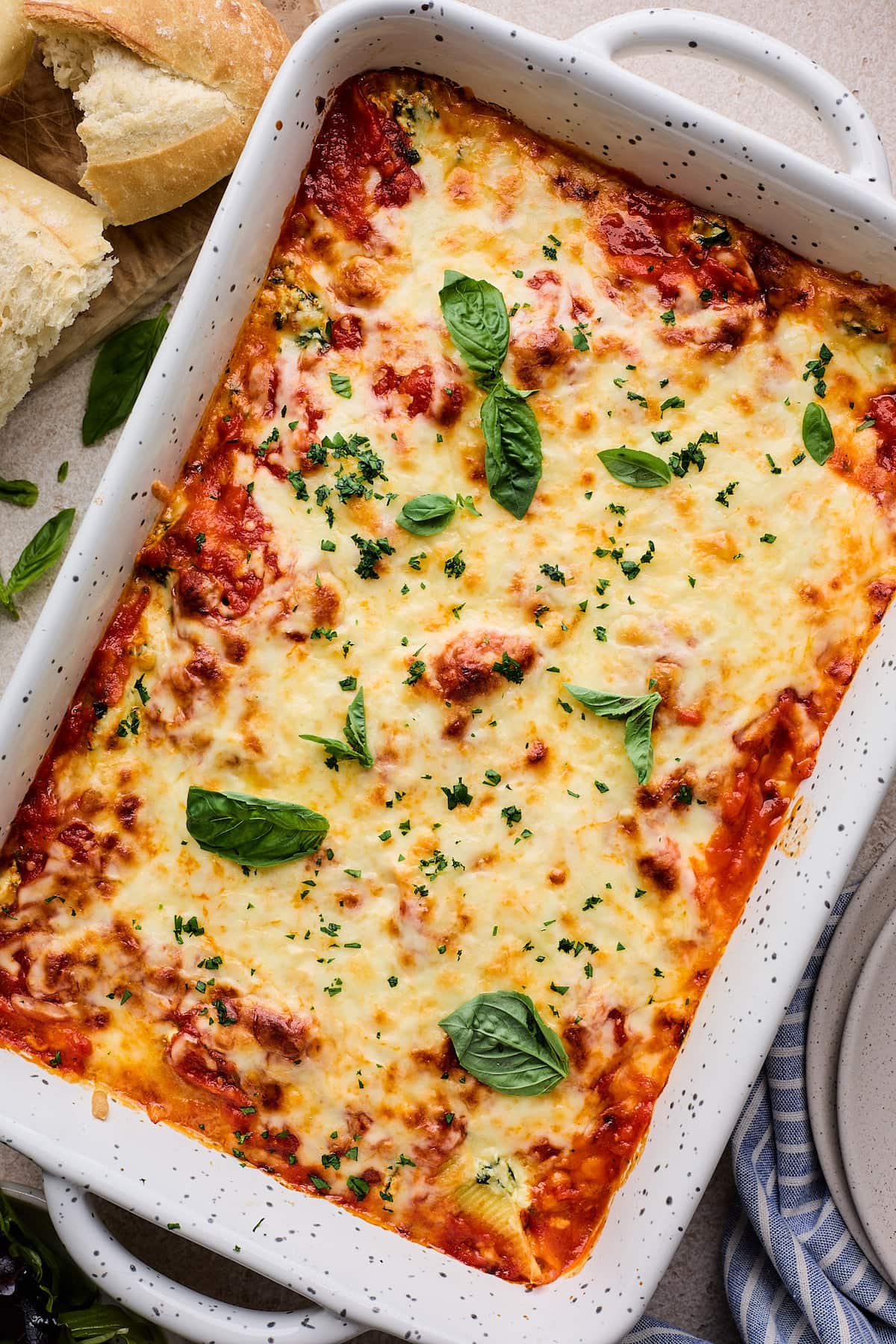 stuffed shells covered in cheese in baking dish. 