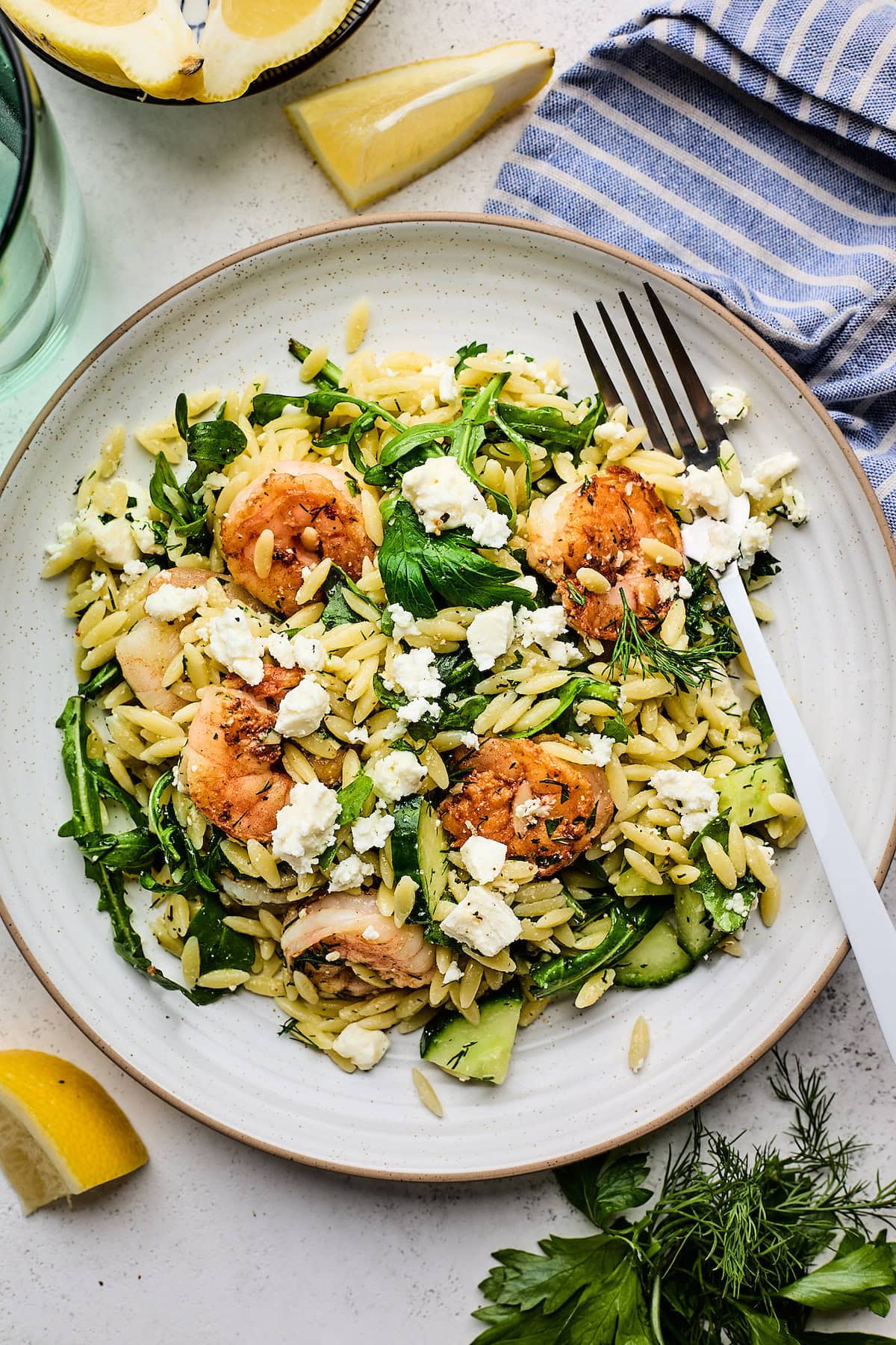 shrimp orzo salad on plate with fork. 