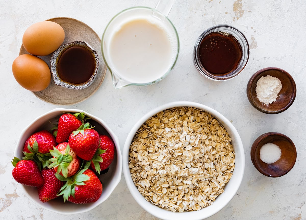 ingredients in bowls to make strawberry baked oatmeal. 