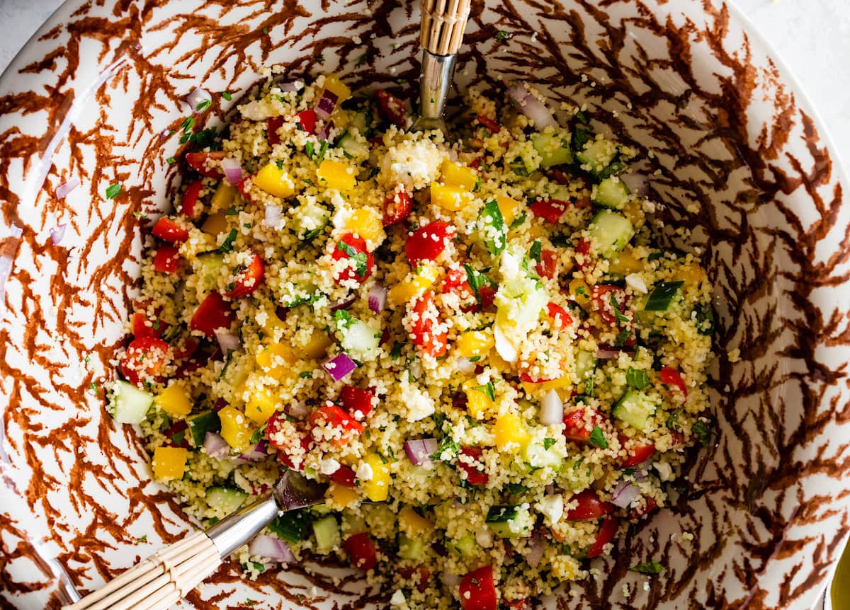 couscous being tossed in mixing bowl. 