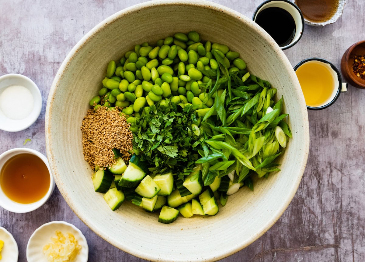 cucumber, edamame, green onion, cilantro, and sesame seeds in bowl. 