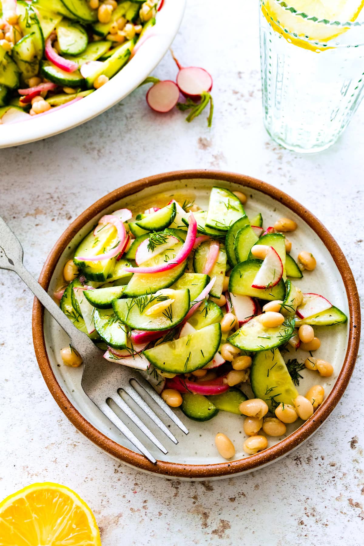 white bean cucumber salad on plate with fork. 