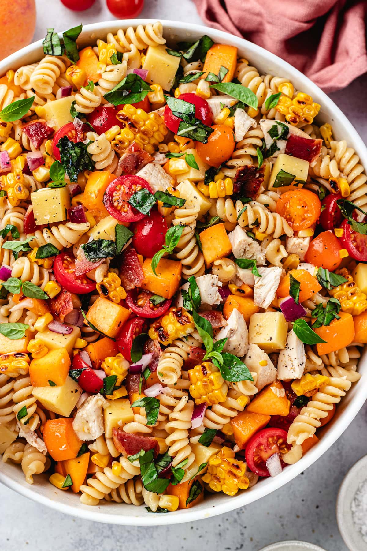 close up of chicken bacon peach pasta salad with hot honey dressing. 