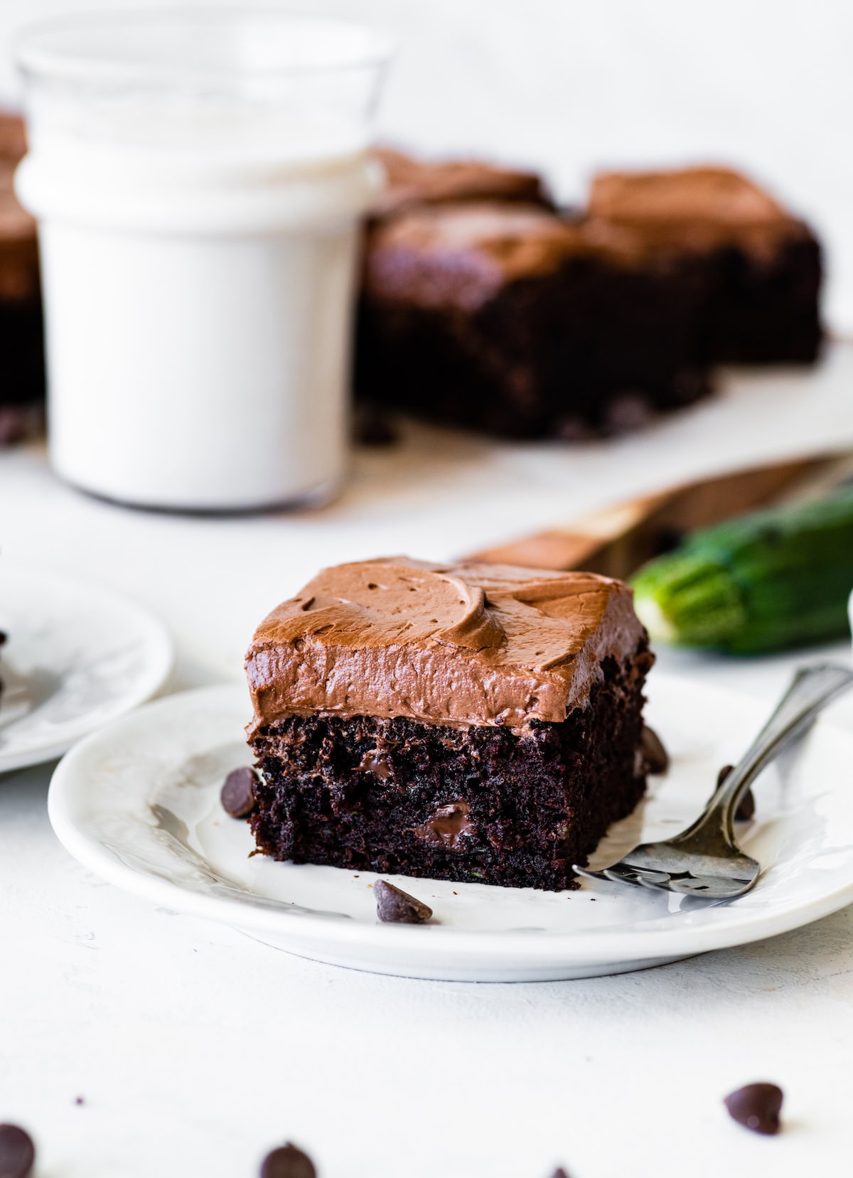 piece of chocolate zucchini cake on plate with fork. 