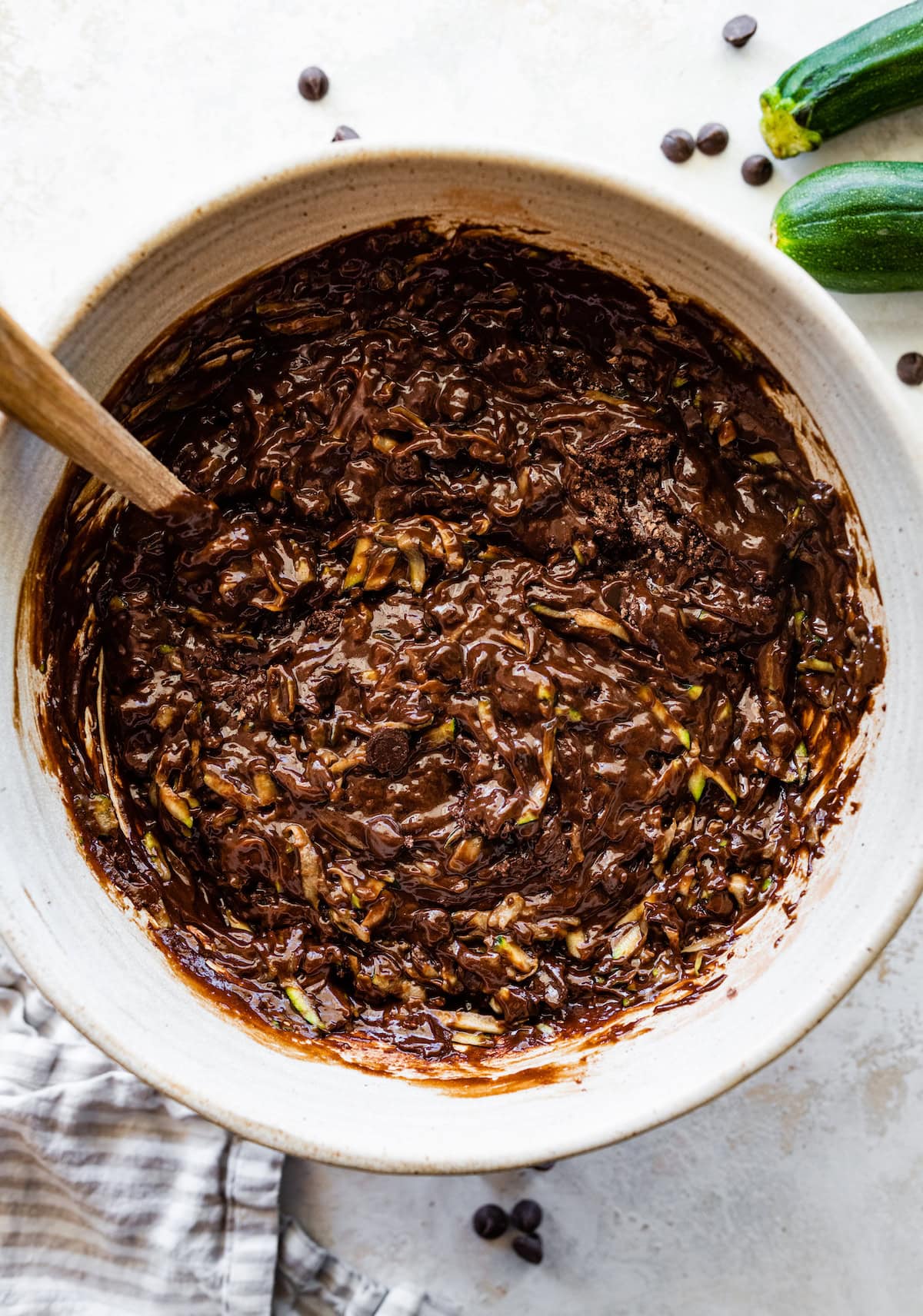 chocolate zucchini cake batter in mixing bowl with spatula. 