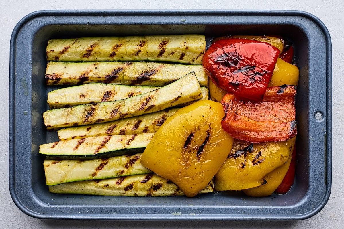 grilled zucchini and bell peppers on tray. 