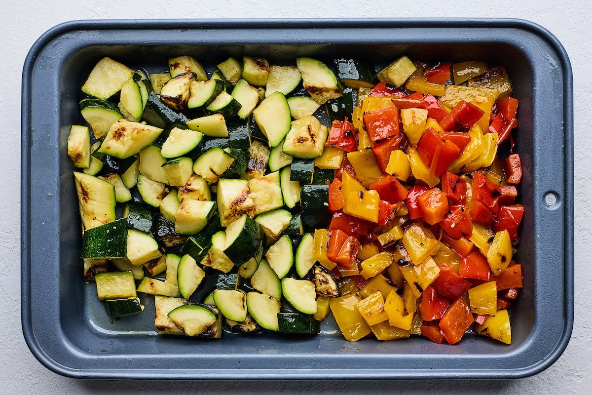 chopped grilled zucchini and bell peppers on tray. 