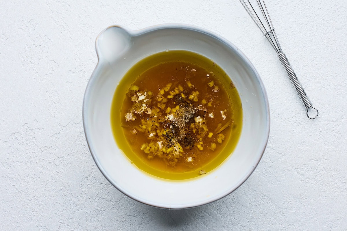 dressing in bowl with small whisk. 