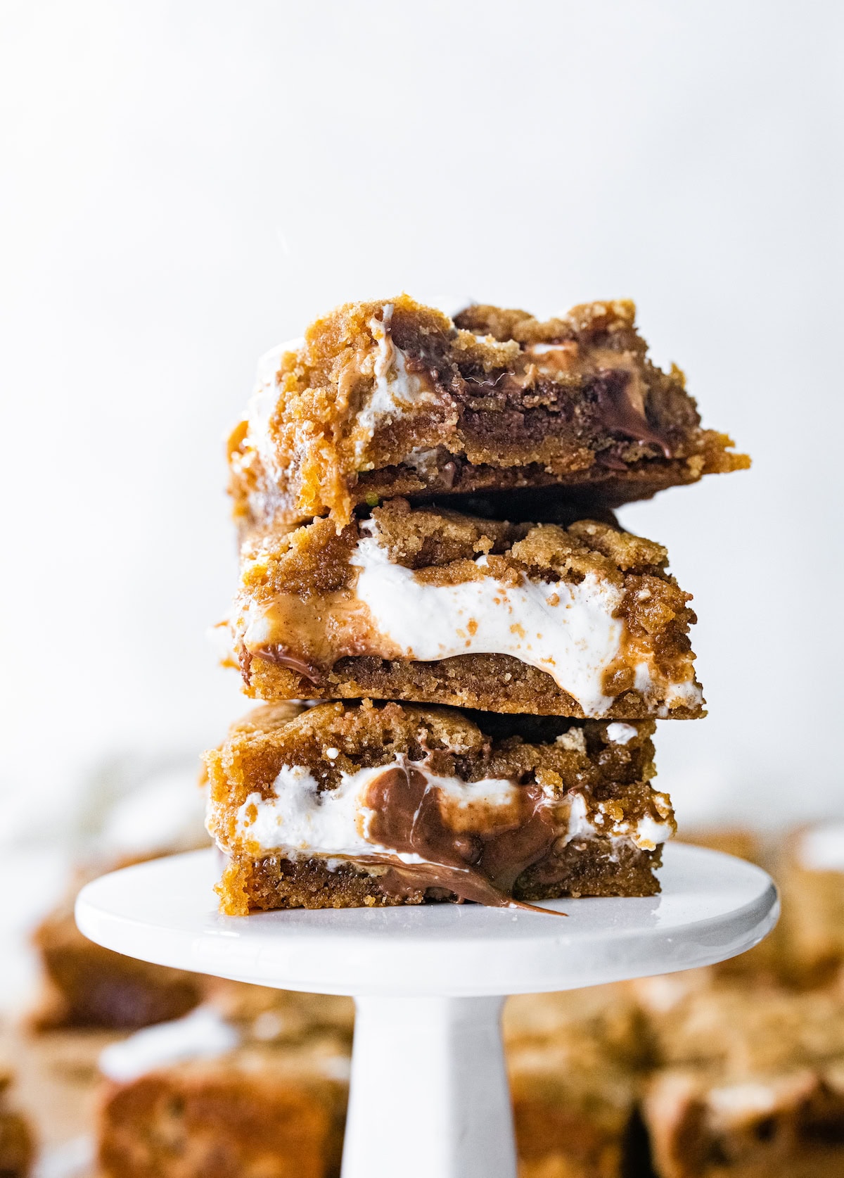 stack of peanut butter s'mores bars on mini cake stand. 