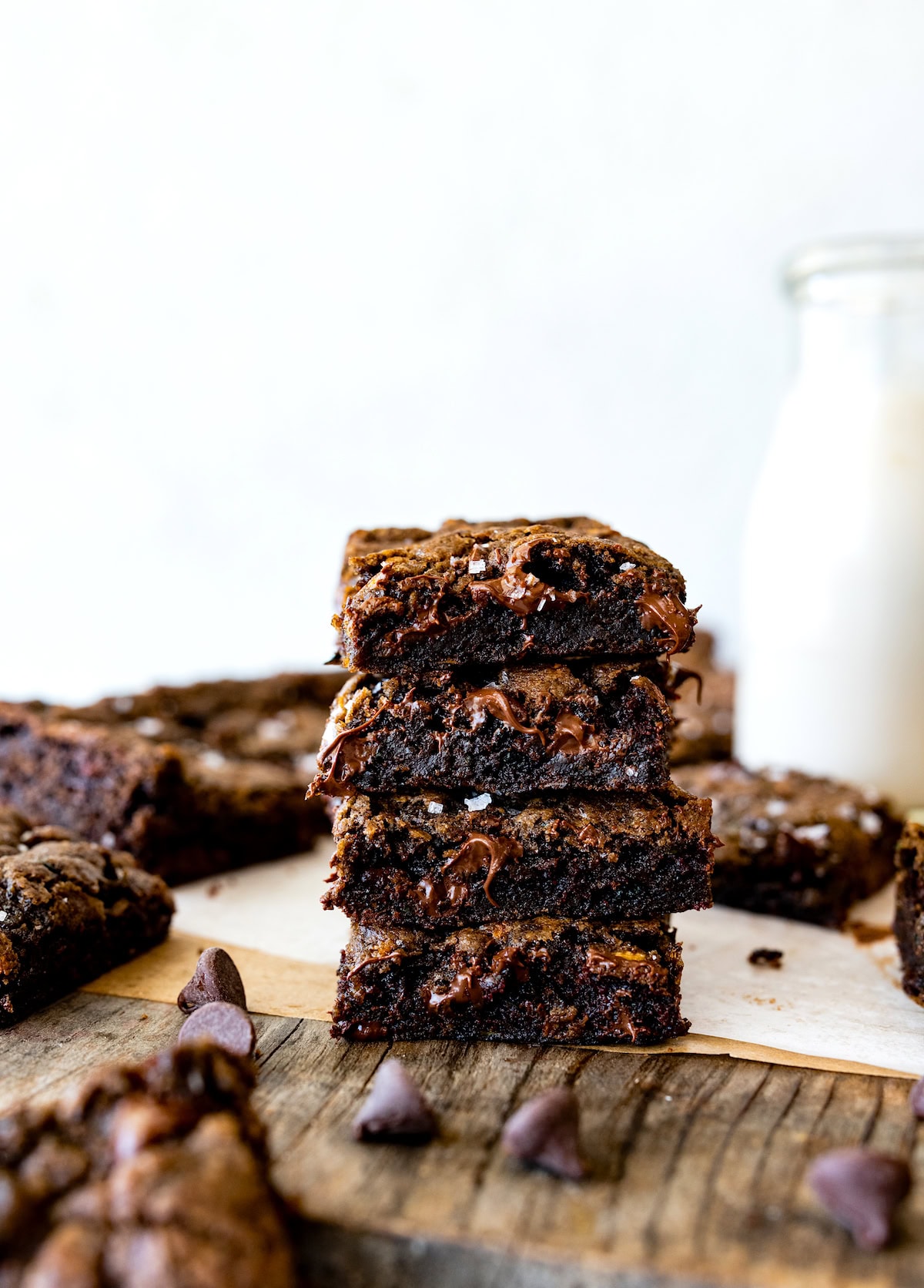 stack of zucchini brownies with bottle of milk. 
