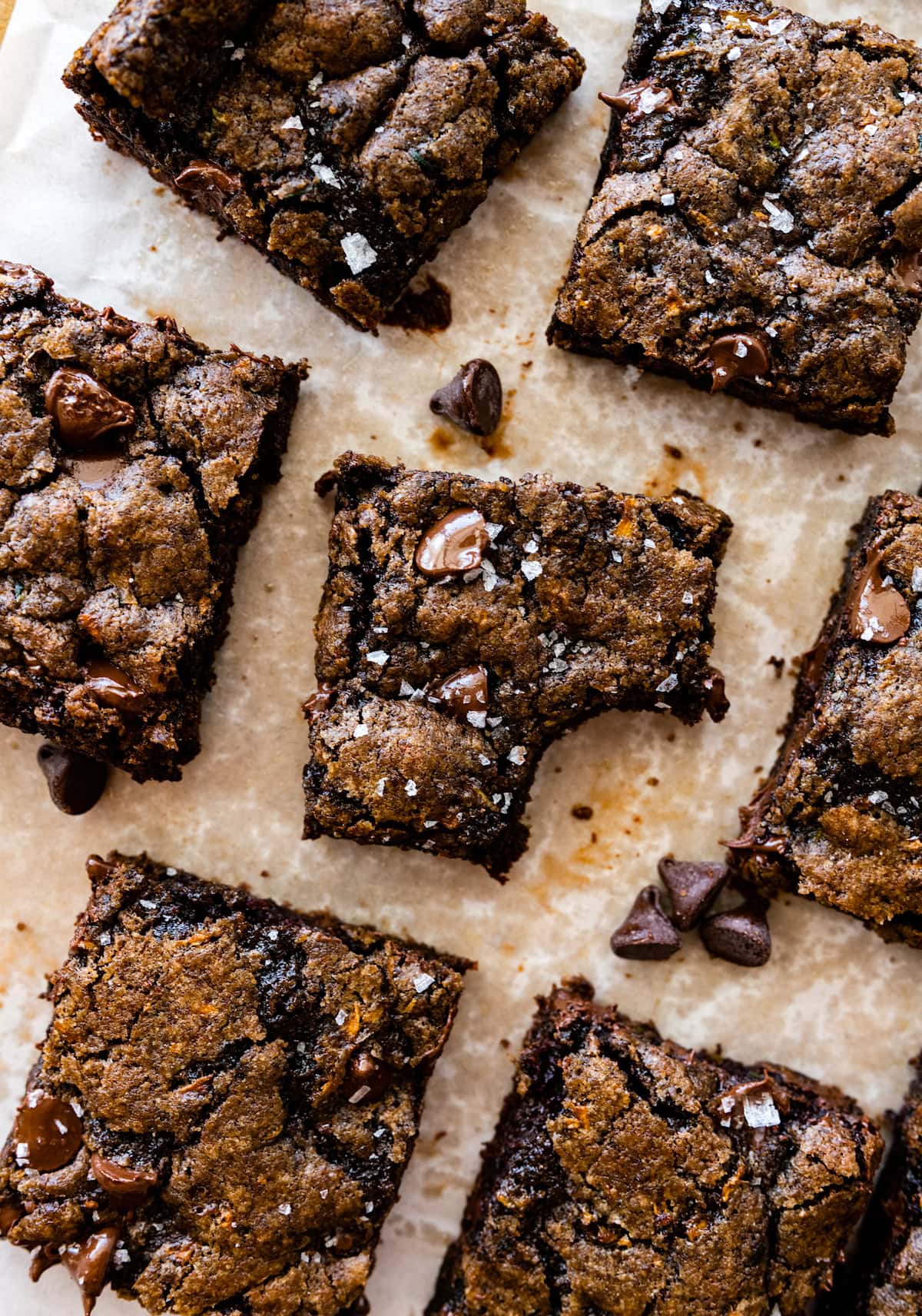 zucchini brownies cut into squares with one missing a bite. 