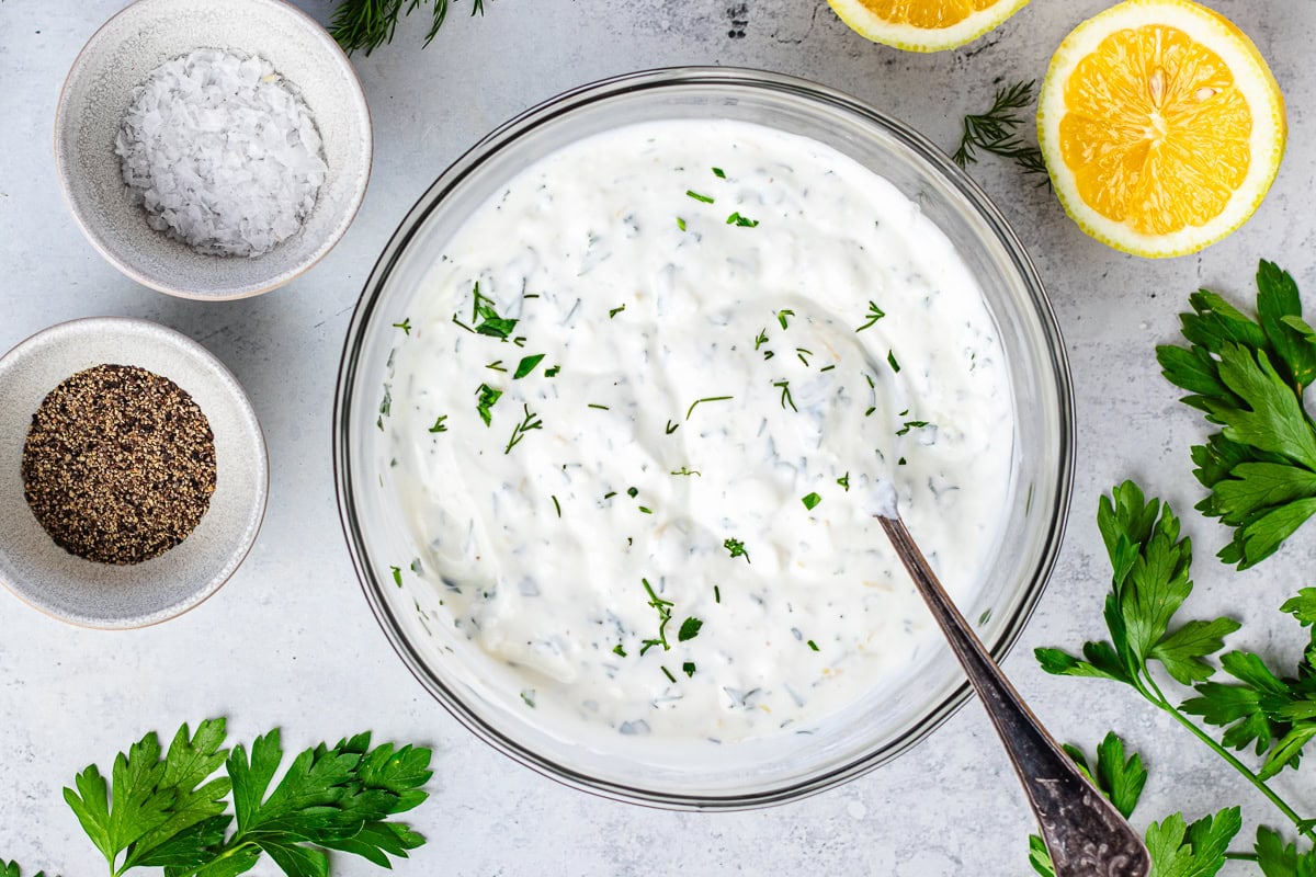 creamy Greek yogurt feta spread in bowl with spoon. 