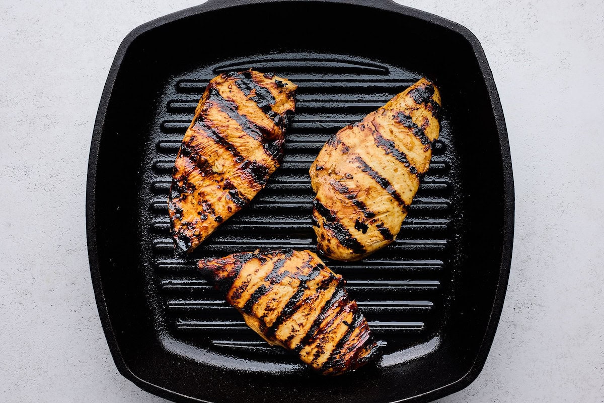 hot honey chicken grilling on grill pan. 