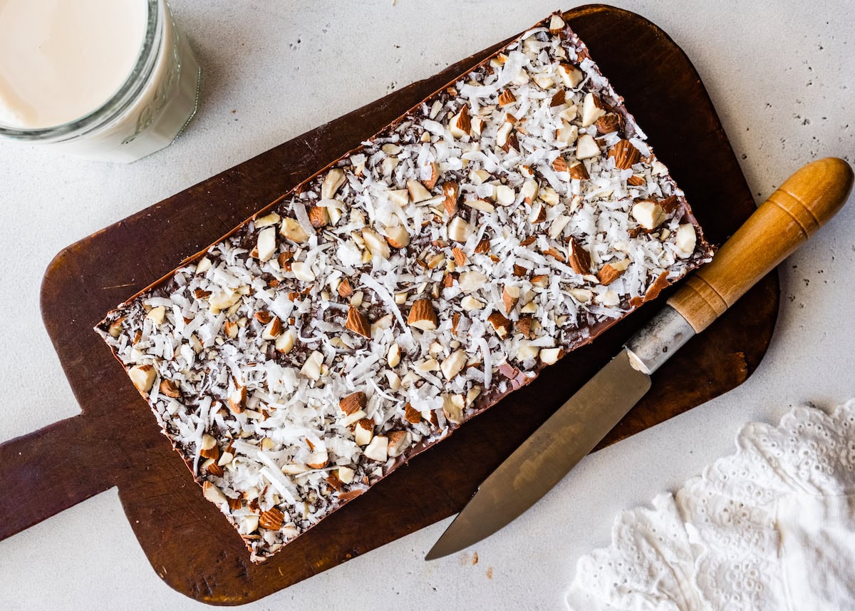 no bake almond joy bars on cutting board with knife. 