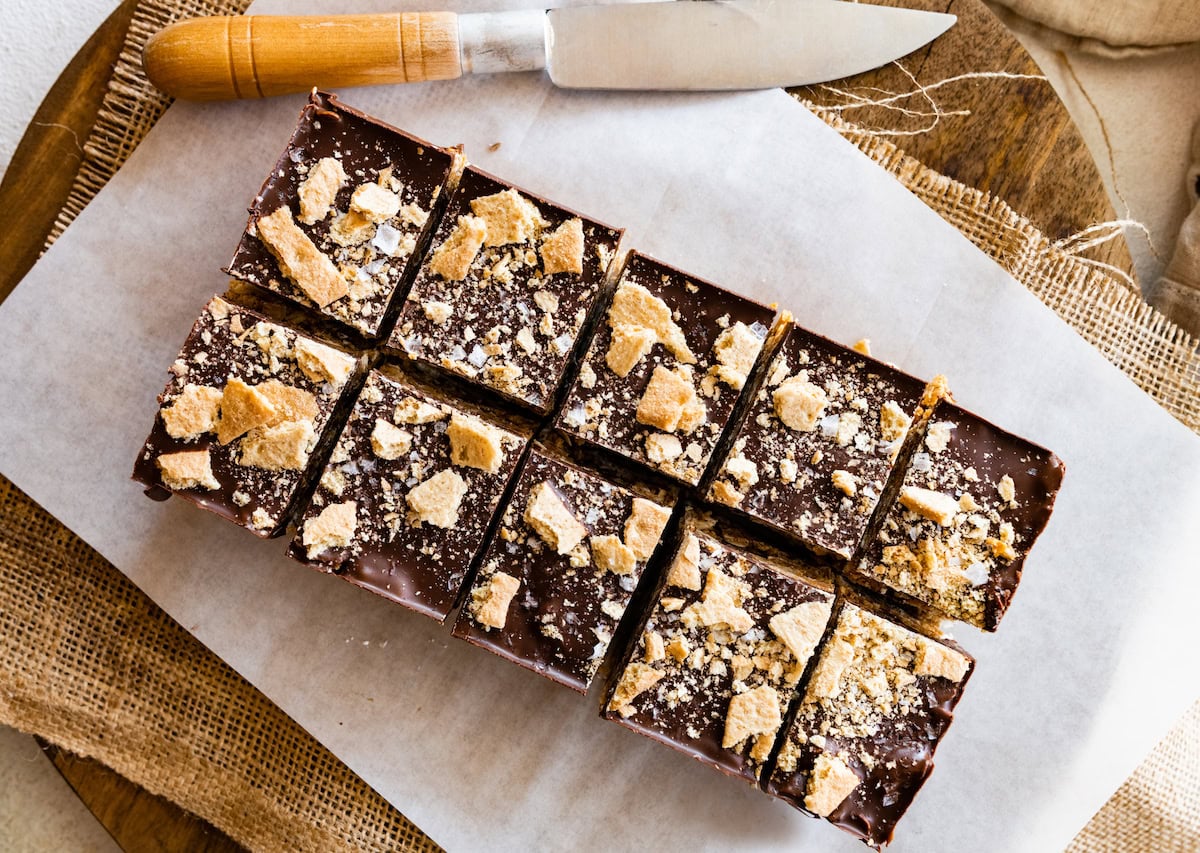 no bake peanut butter s'mores bars cut into squares on parchment paper. 