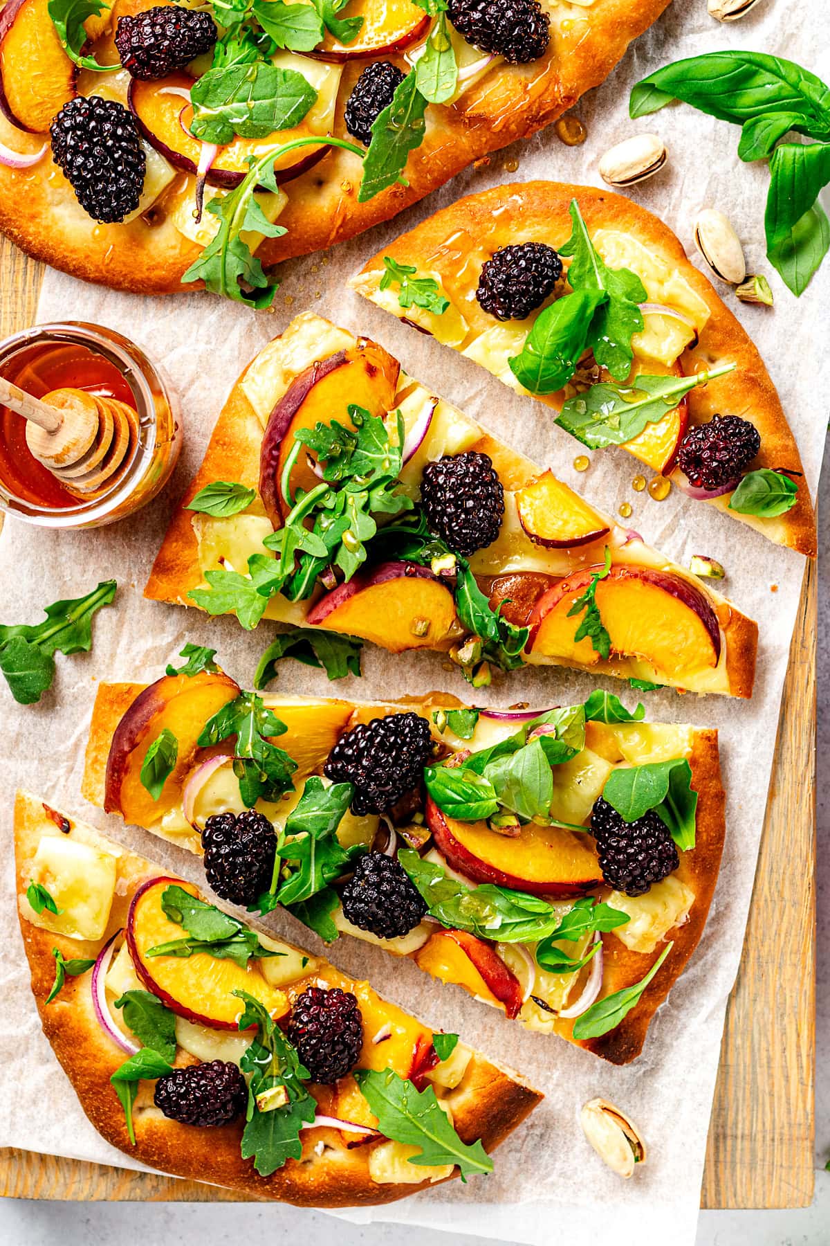 peach brie flatbread with blackberries, arugula, pistachios, and honey. 