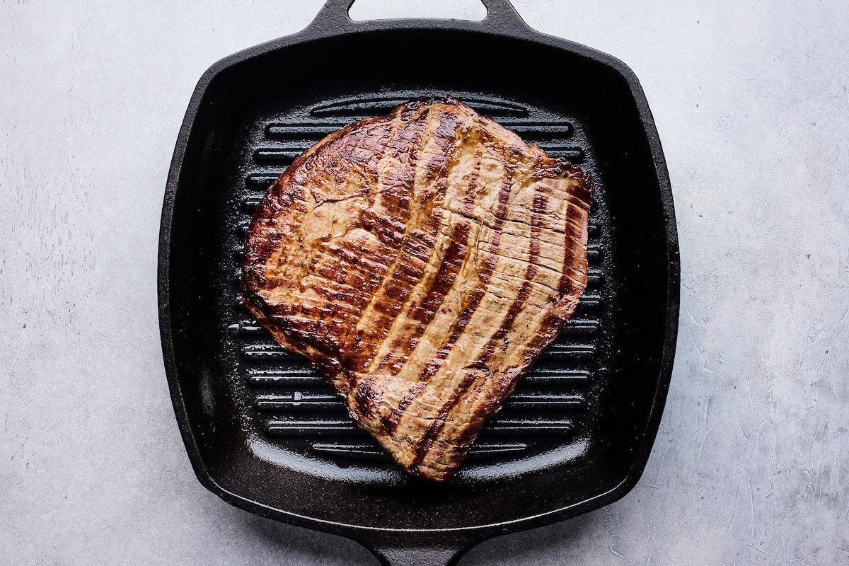 steak grilling on grill pan. 