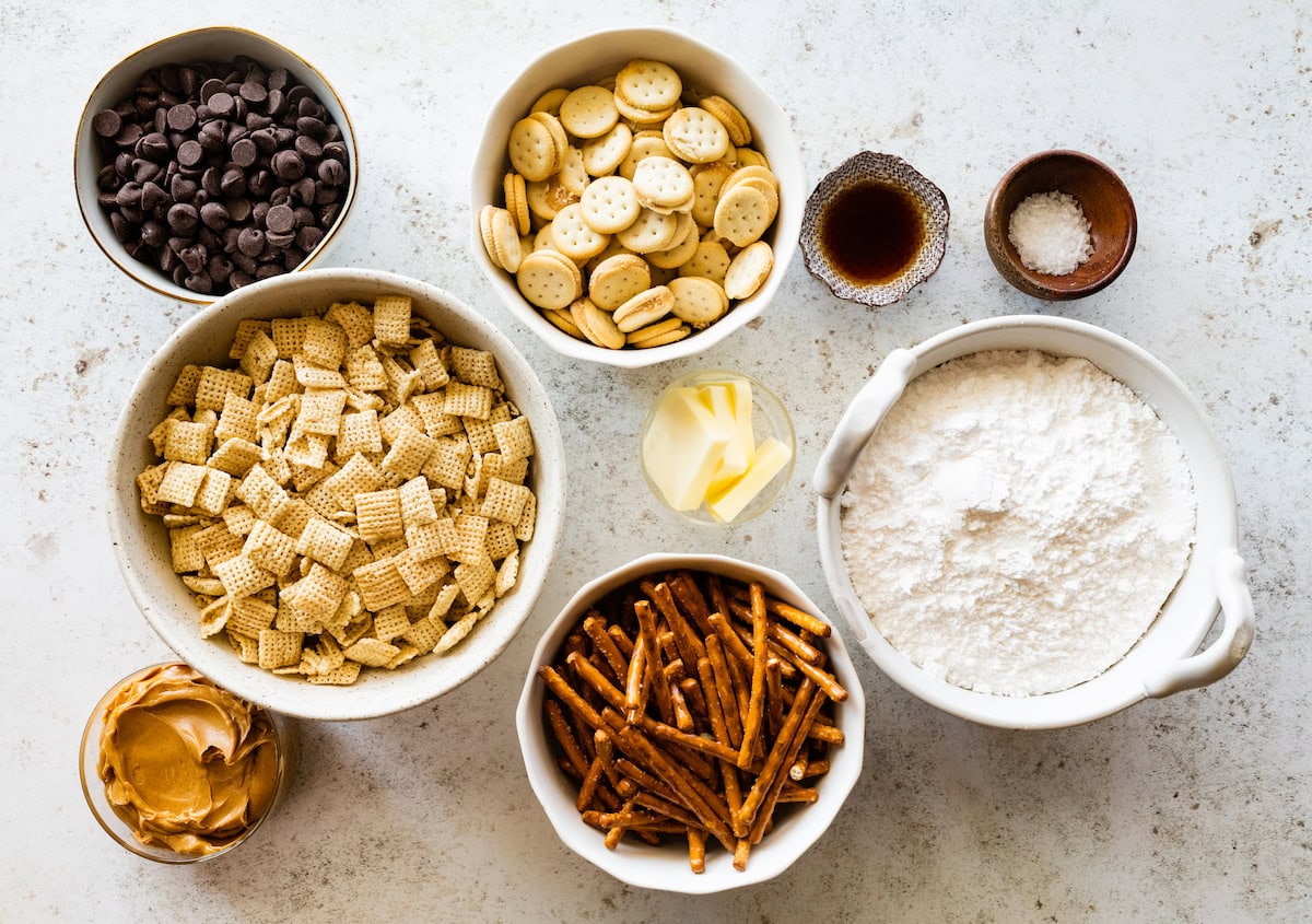 ingredients in bowls to make sweet and salty puppy chow. 