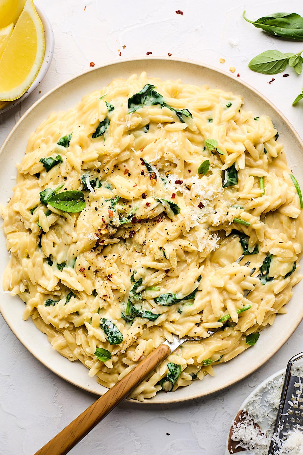 creamy orzo on plate with fork. 