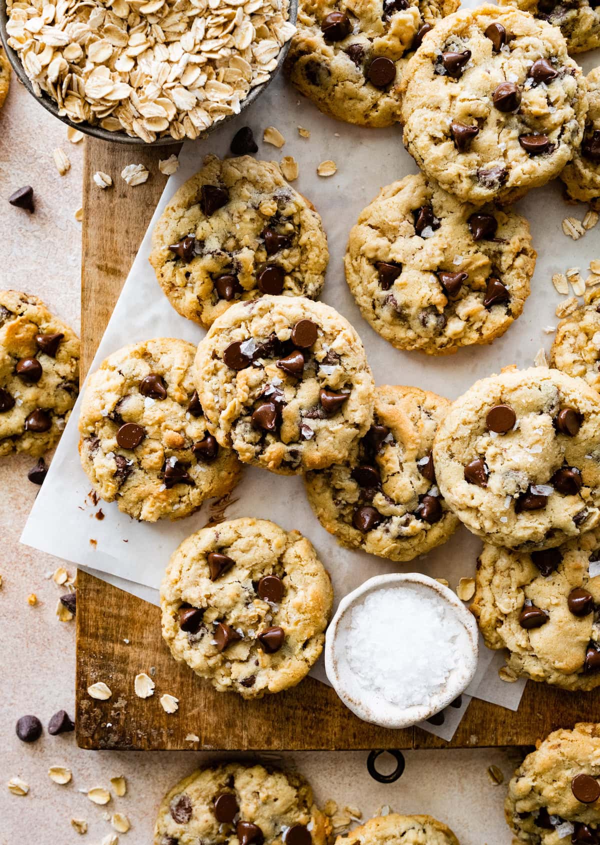 oatmeal chocolate chip cookies on wood board with parchment paper. 