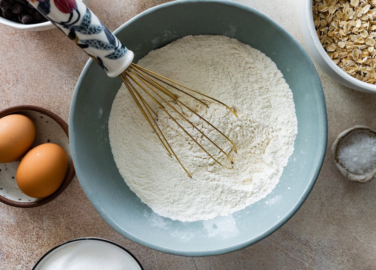 dry ingredients being whisked together in mixing bowl. 