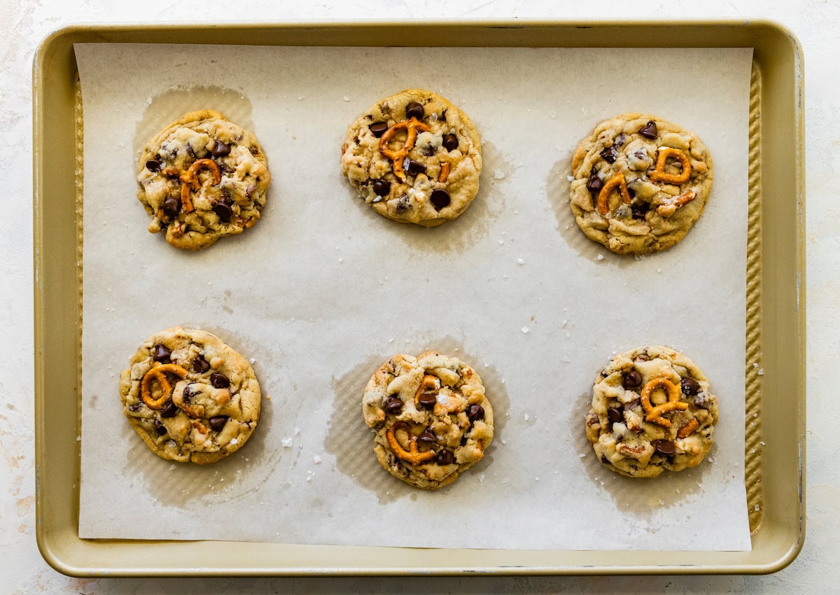 pretzel toffee chocolate chip cookies on baking sheet with parchment paper. 