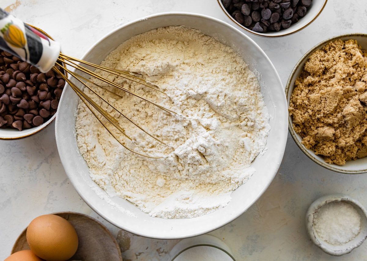 dry ingredients being whisked together in bowl. 