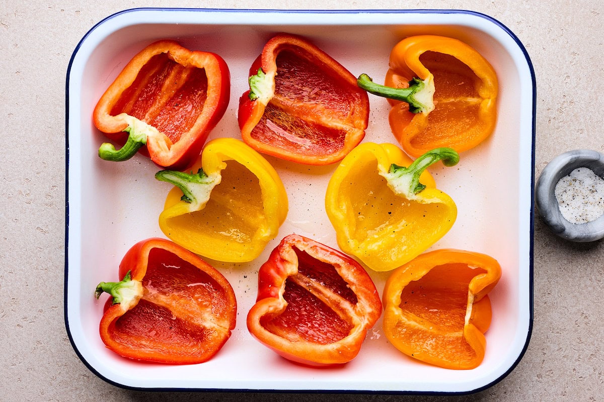 bell peppers cut in half in pan to make stuffed peppers. 