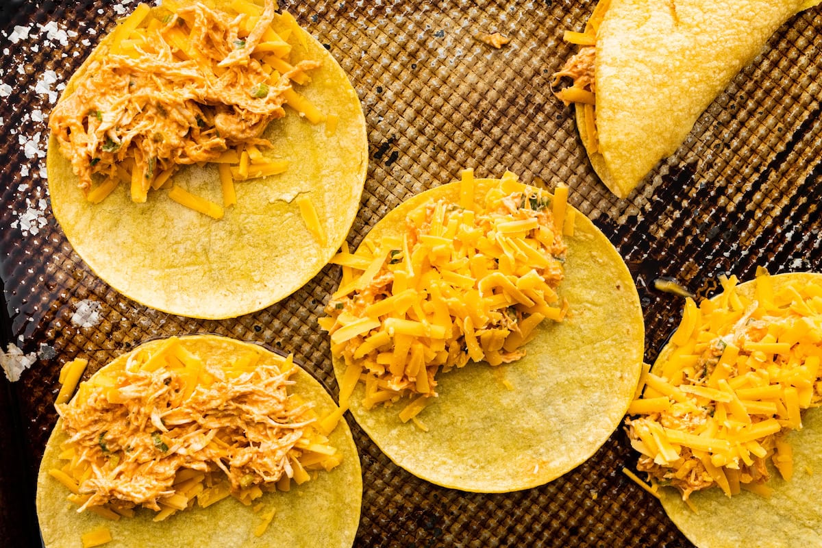 buffalo chicken mixture and cheese on top of corn tortillas. 