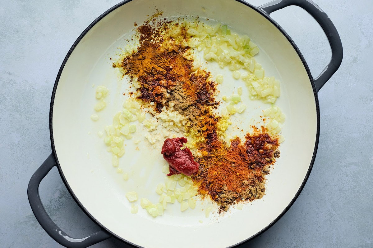 onion, garlic, spices, and tomato paste in pot to make tikka masala meatballs. 