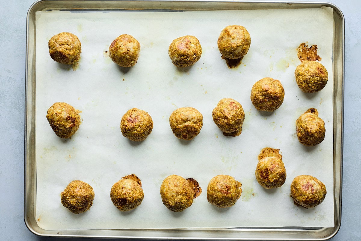 cooked tikka masala meatballs om baking sheet. 