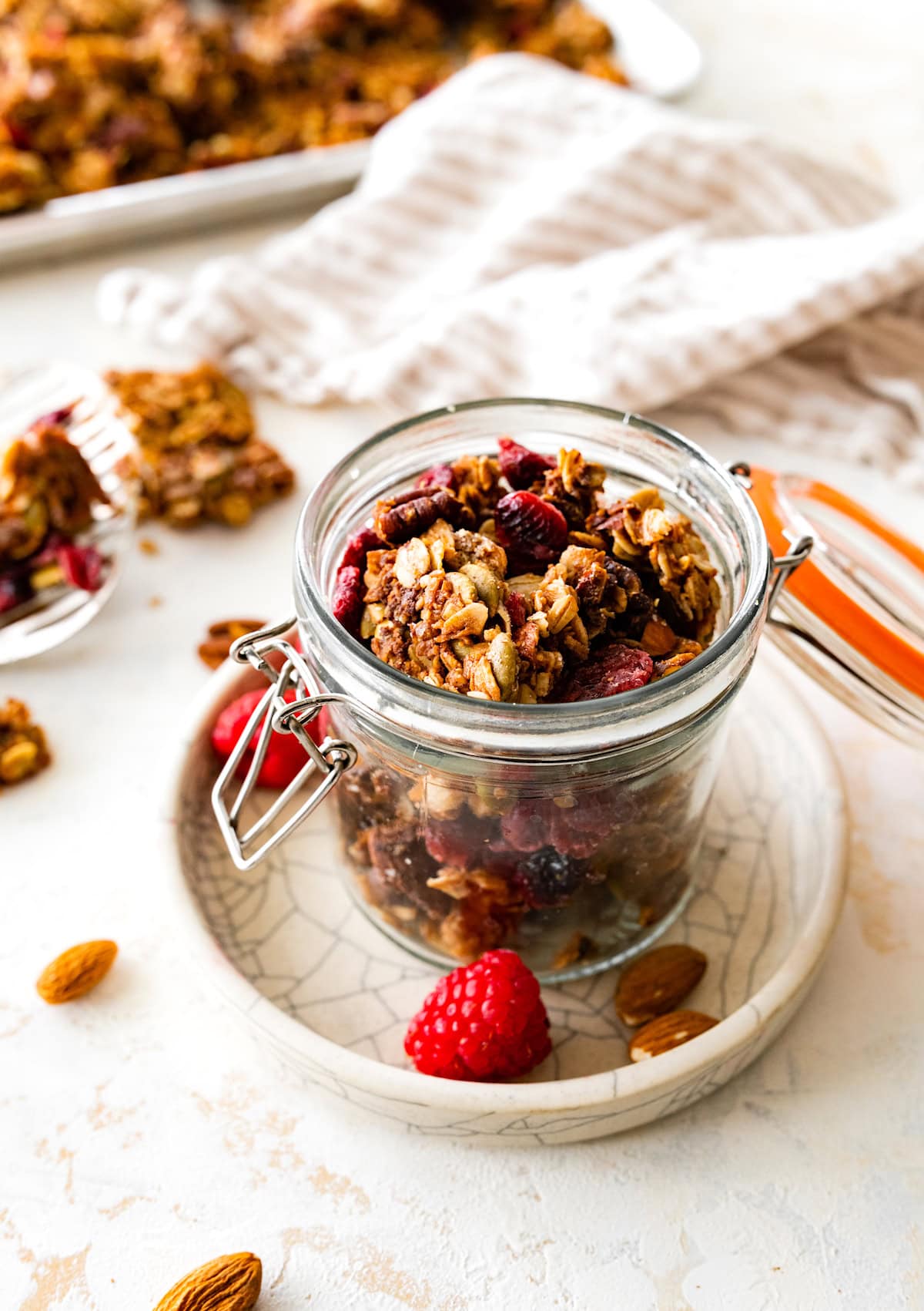 granola in small glass jar on plate. 