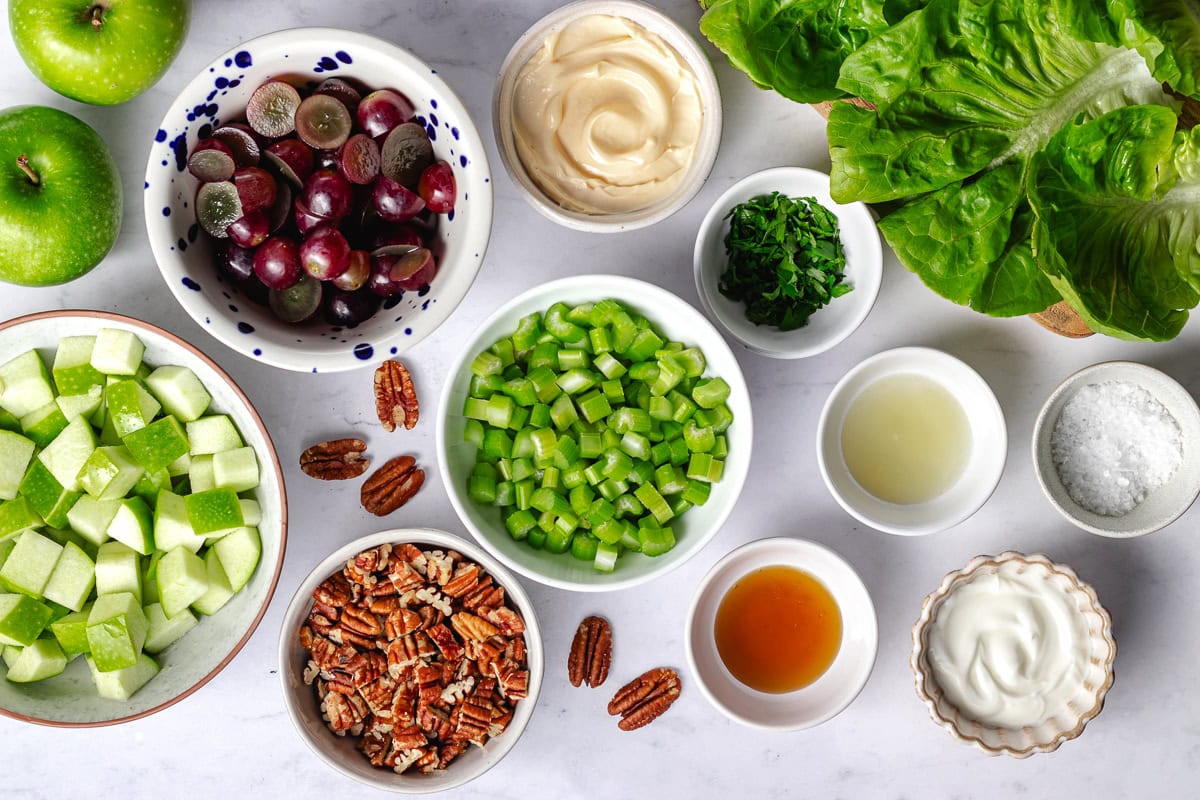 waldorf salad ingredients in bowls. 