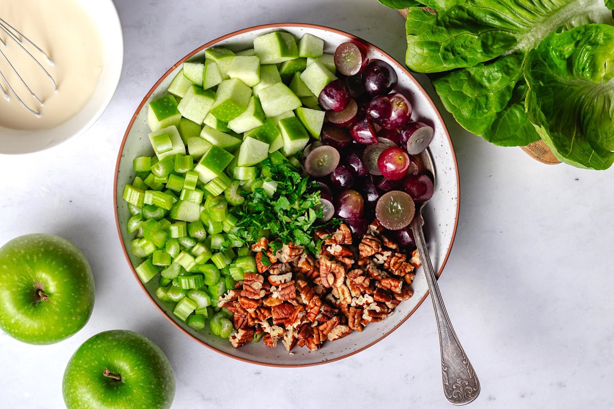 waldorf salad ingredients in serving bowl. 