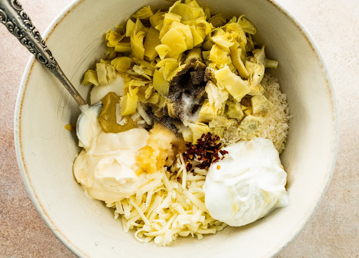 ingredients in mixing bowl to make artichoke dip. 