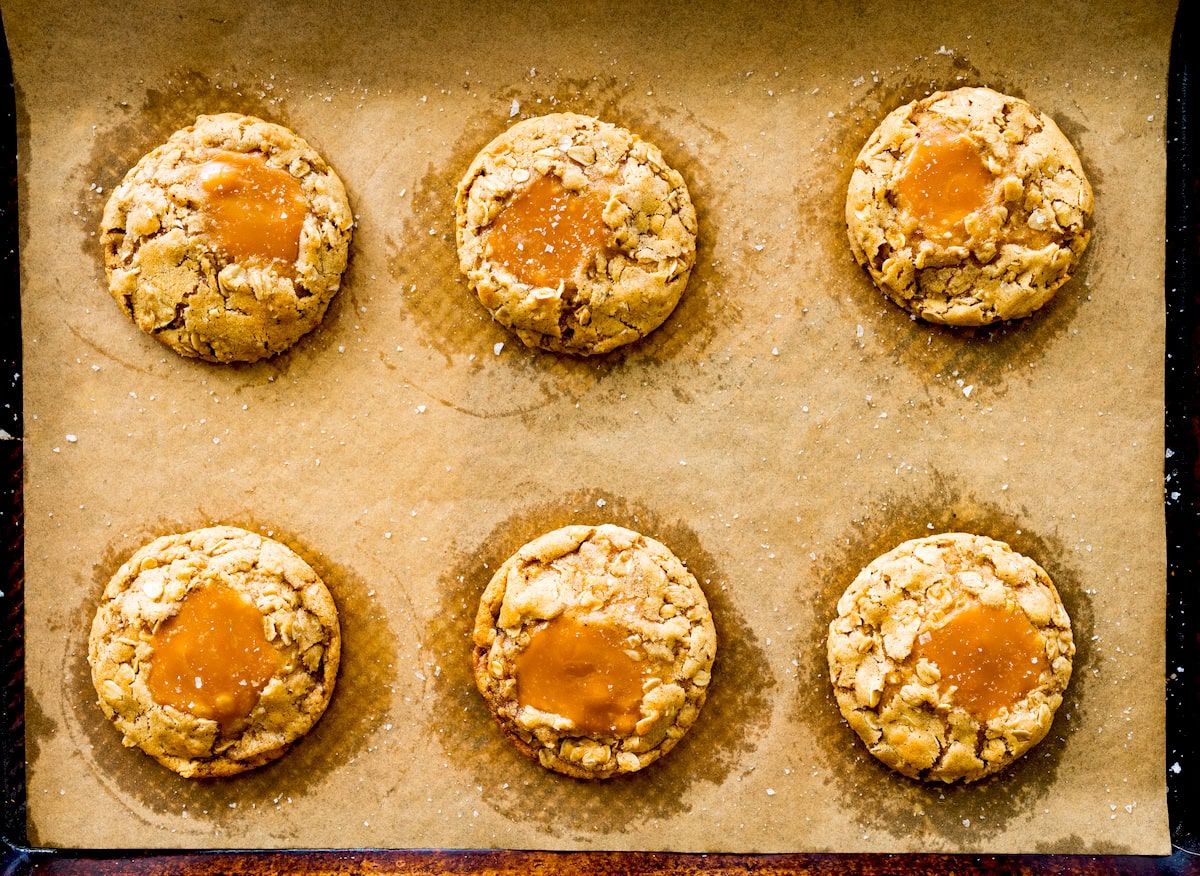 brown butter caramel oatmeal cookies on baking sheet with parchment paper. 