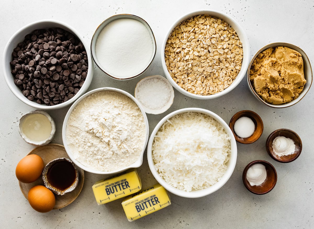 ingredients in bowls to make chocolate dipped coconut cookies. 