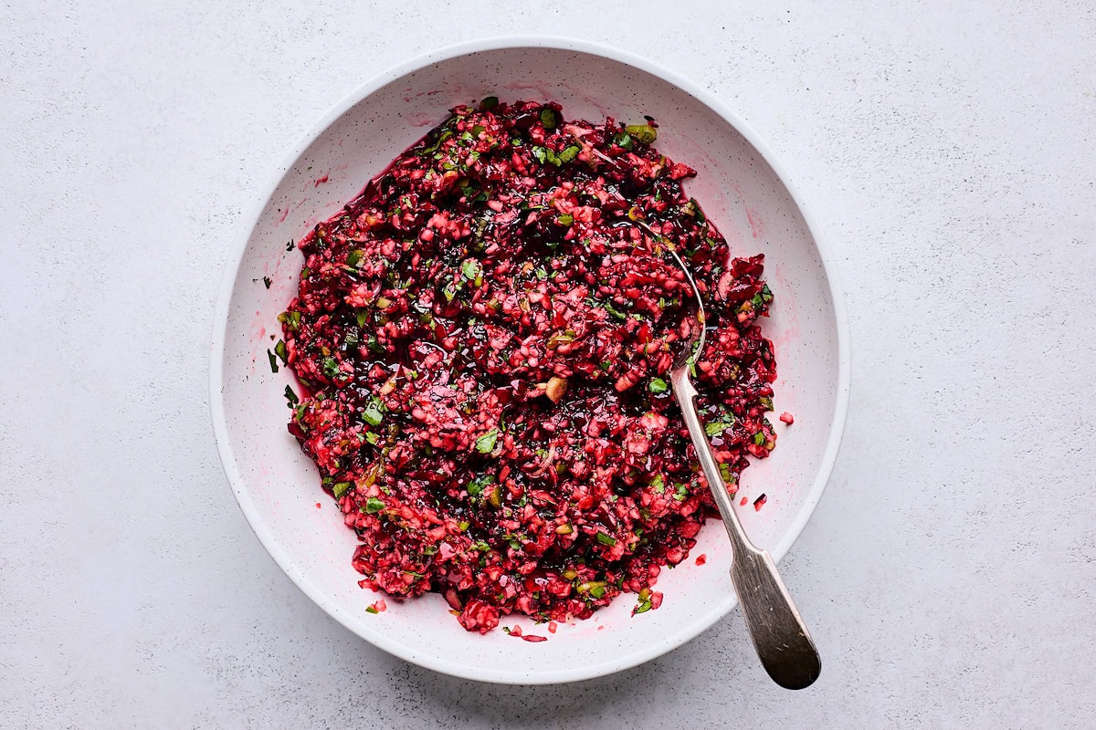 cranberry salsa in bowl with spoon. 